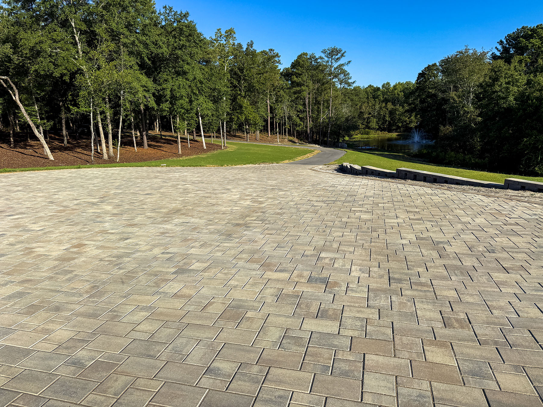Paver driveway and forecourt overlooking landscaped grounds